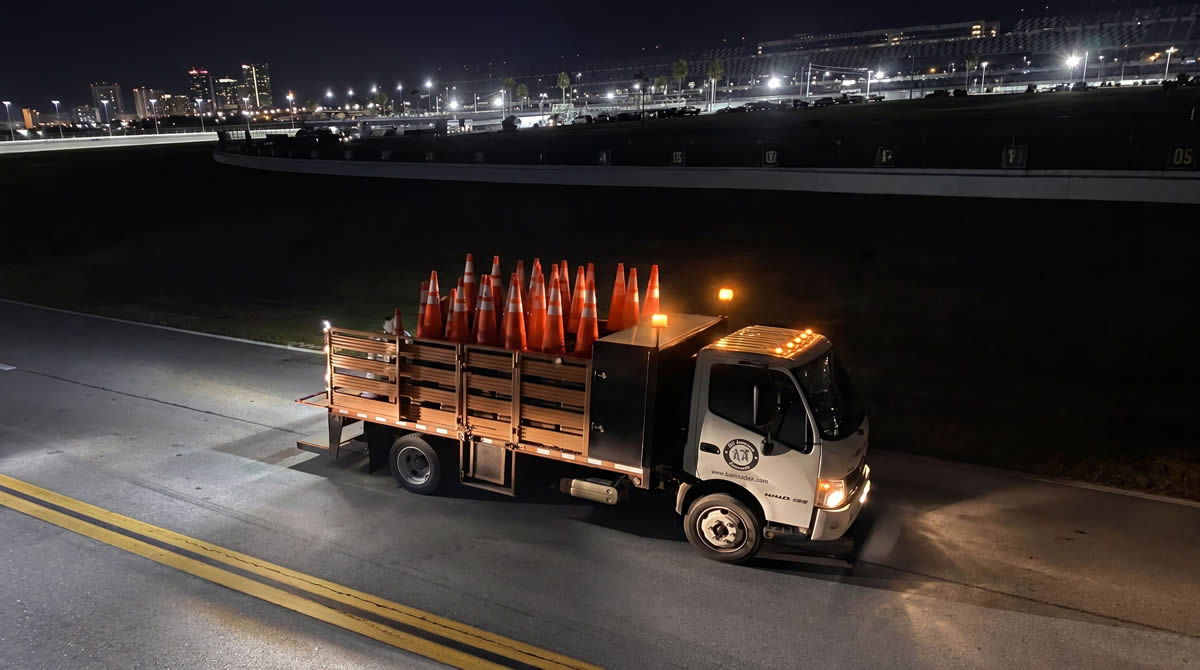 Road-safety client truck stacked with traffic cones at a Florida raceway